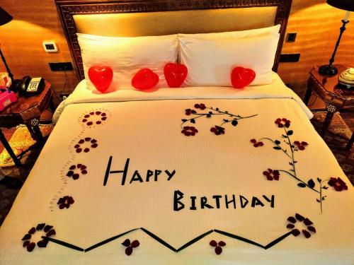 a bed with a happy birthday written on it at Shri Vasudev Dham in Vrindāvan