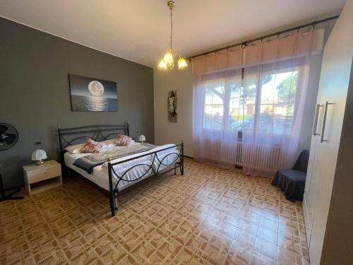 a bedroom with a bed and a large window at Casa Variante in Cannobio