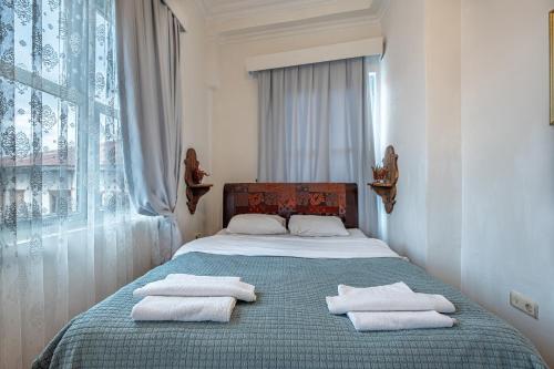 a bedroom with a bed with towels on it at Villa Tulipan in Antalya