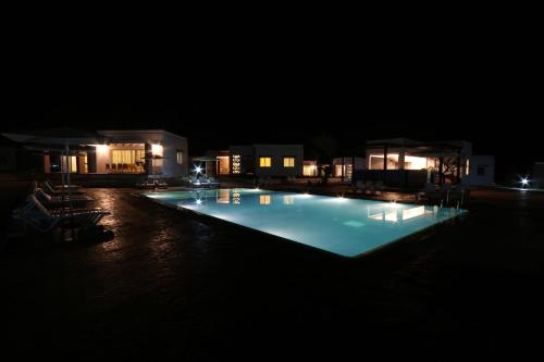 a large swimming pool lit up at night at Lunja Village - Agadir in Taghazout
