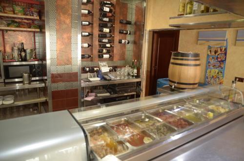 a kitchen with a counter with many trays of food at Pension Cuatro Vientos in Cuevas del Almanzora