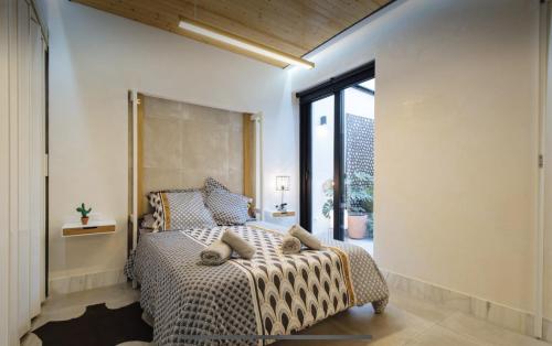 a bedroom with a bed with a cheetah print blanket at Lujoso loft con piscina y espacio office in Seville