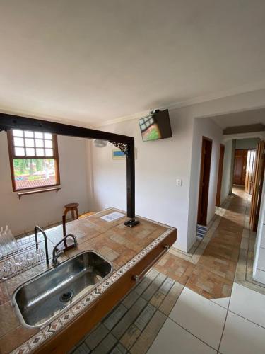 a kitchen with a sink and a counter top at Quinta Da Estalagem in Pirenópolis