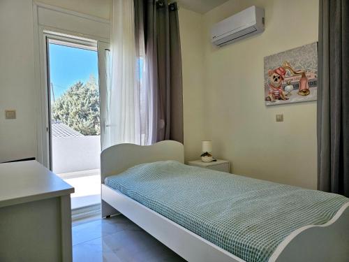 a bedroom with a bed and a large window at Dream Luxury Suites & Apartment in Pastida