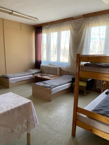 a room with three bunk beds in a room at Centrum Panzió in Kaposvár