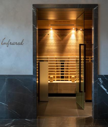 a glass door leading into a room with a couch at Falkensteiner Schlosshotel Velden – The Leading Hotels of the World in Velden am Wörthersee