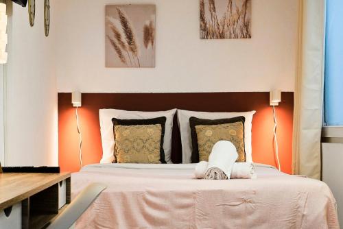a bedroom with a large bed with orange walls at Large studio between train station & Grand Place in Lille