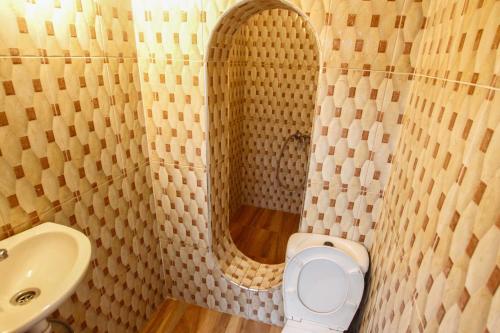 a bathroom with a sink and a toilet and a mirror at White And Blue in Essaouira