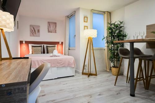 a bedroom with a bed and a table and chairs at Large studio between train station & Grand Place in Lille