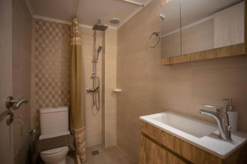 a bathroom with a sink and a toilet and a shower at Galini Studio, next to the beach in Rethymno Town