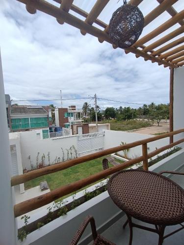 a balcony with a table and chairs and a view at Flats Marina Maragogi in Maragogi