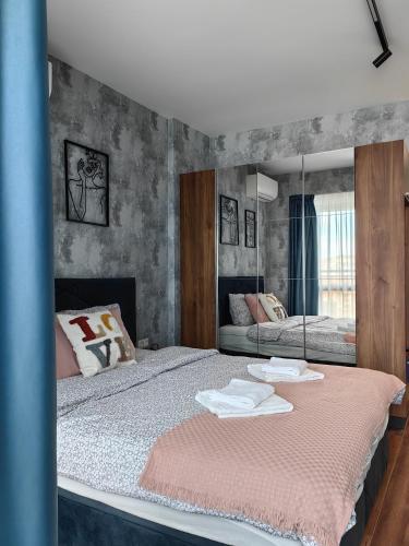 a bedroom with two beds and a mirror at Luxury Apartment/Studio in Plovdiv