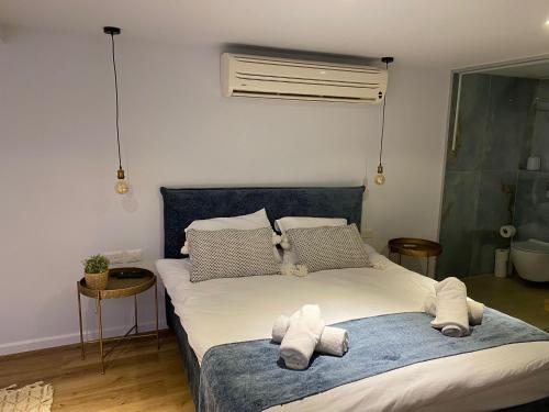 a bedroom with a large bed with towels on it at Hakochav in Eilat