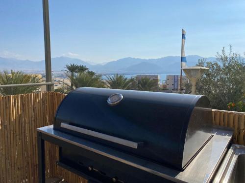 a black grill sitting on top of a fence at Hakochav in Eilat