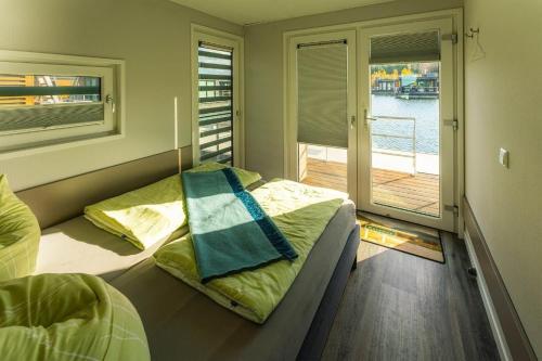 two beds in a room with a view of the water at Hausboot Paradise in Klitten