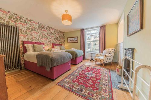 a bedroom with two beds and a rug at Tastefully decorated, family friendly property, central Kirkby Lonsdale, parking and EV charger in Kirkby Lonsdale