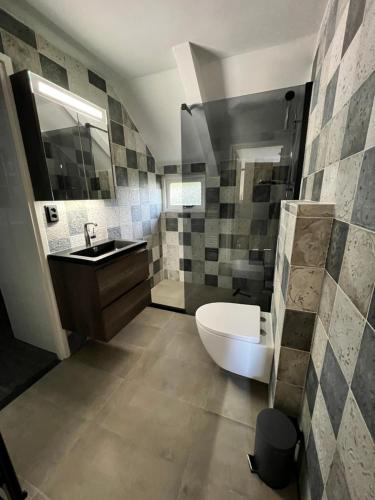 La salle de bains est pourvue de toilettes, d'un lavabo et d'une baignoire. dans l'établissement Vakantie huis Ermelo, à Ermelo