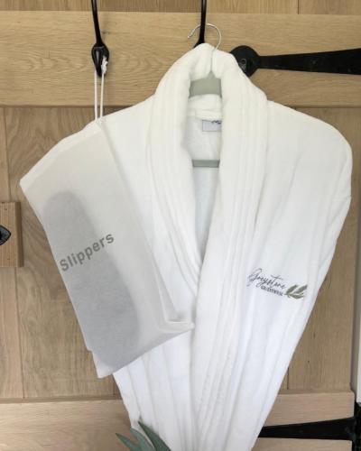 a white shirt and tie hanging on a rack at Greystone Guesthouse in Titchmarsh