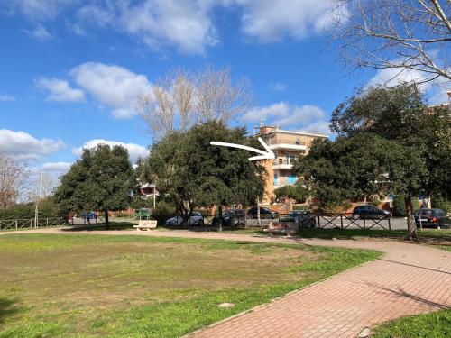 a white frisbee in the air in a park at Espo's house in Torvaianica