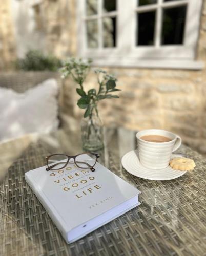 a book and a cup of coffee on a table at Greystone Guesthouse in Titchmarsh
