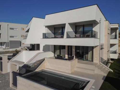 an image of a white building with a balcony at Luxury Villas Travera in Novalja