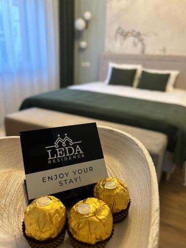 two yellow cupcakes on a plate with a sign at Leda Residence in Oradea