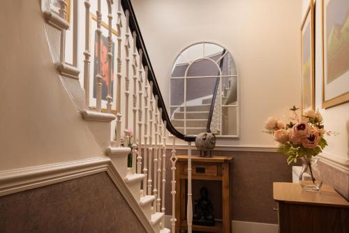 a hallway with a spiral staircase with a mirror at School View in Melrose