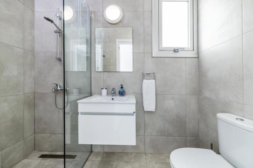a bathroom with a shower and a sink and a toilet at PROTARAS HEIGHTS in Protaras