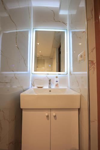 a bathroom with a sink and a mirror at Villa Abedini in Ksamil