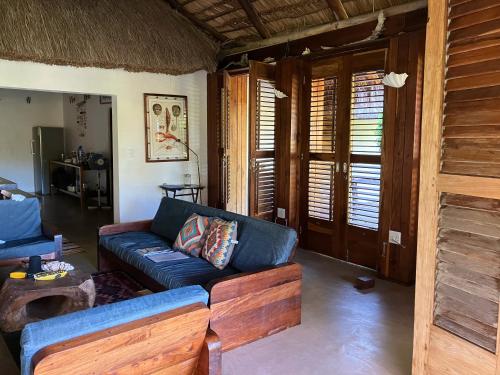 a living room with a couch and a table at Ebony Beach in Vilanculos
