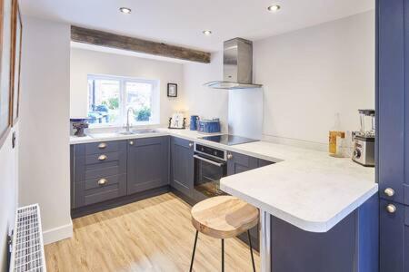 a kitchen with blue cabinets and a white counter top at Host & Stay - 2 College Square in Stokesley