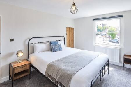 a bedroom with a large bed and a window at Host & Stay - 2 College Square in Stokesley