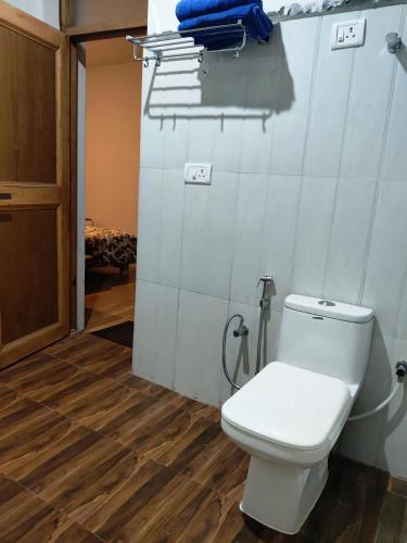 a bathroom with a toilet in a room at Lynx near Leh airport in Leh