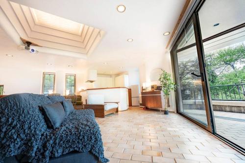 a bedroom with a bed and a large window at Open-air bath & Private hot-spring Villa in Hakone in Onsensō