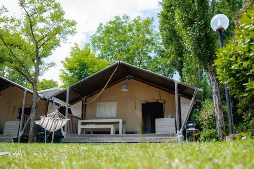 a house with a hammock in front of it at Glamping Florence in Troghi