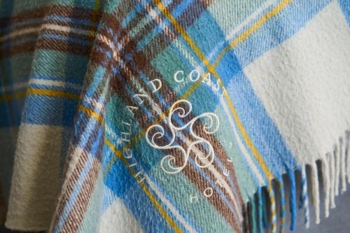 a close up of a plaid blanket with a design on it at Plockton Inn in Plockton