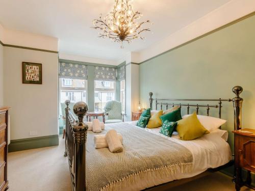 a bedroom with a large bed and a chandelier at 3 bed in Broadstairs 86736 in Broadstairs