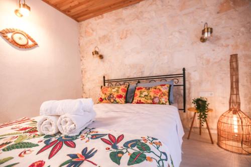a bedroom with a bed with towels on it at Kandybos Eco Farm Village in Kas