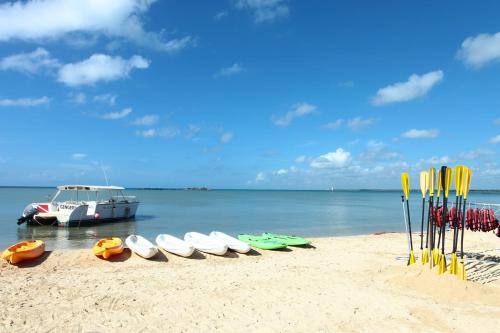 a group of surfboards and a boat on the beach at Bahia Principe Luxury Bouganville - Adults Only All Inclusive in La Romana