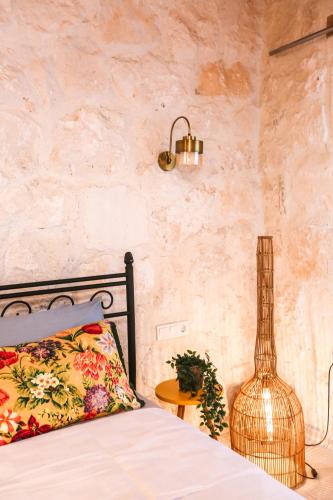 a bedroom with a bed and a table with a lamp at Kandybos Eco Farm Village in Kas