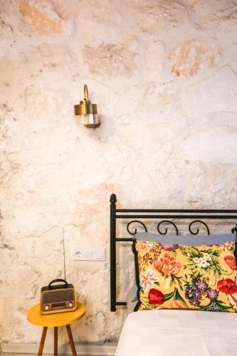a bedroom with a bed with a pillow and a table at Kandybos Eco Farm Village in Kas