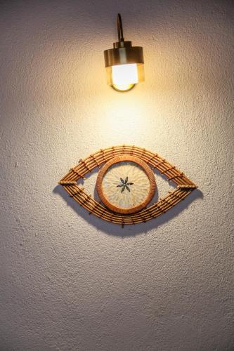 a clock hanging on a wall with a light at Kandybos Eco Farm Village in Kas