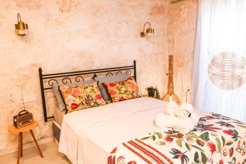 a bedroom with a bed with a floral bedspread at Kandybos Eco Farm Village in Kas