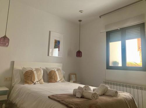 a bedroom with a white bed with towels on it at Estudio5 in Tudela