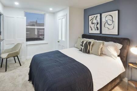 a bedroom with a bed and a chair and a window at Host & Stay - High Street Cottage in Norton