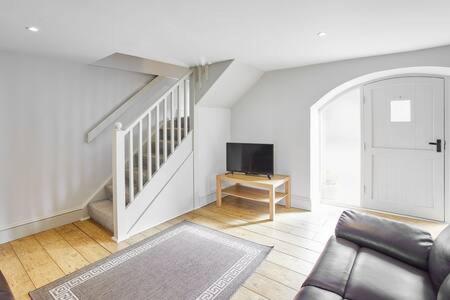 a living room with a couch and a stair case at Host & Stay - Mill in Consett