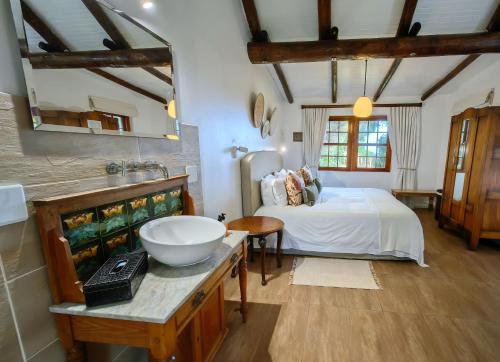 a bathroom with a bed and a sink in a room at Oyster Bay Lodge in Oyster Bay