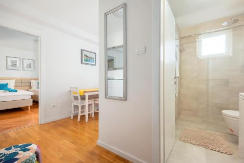 a bathroom with a shower and a toilet in a room at Apartment Mares in Split