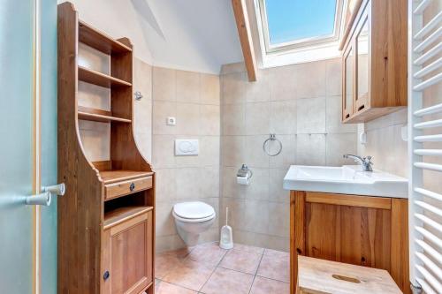 a bathroom with a sink and a toilet and a window at Dia Mare, EG West in Ueckeritz