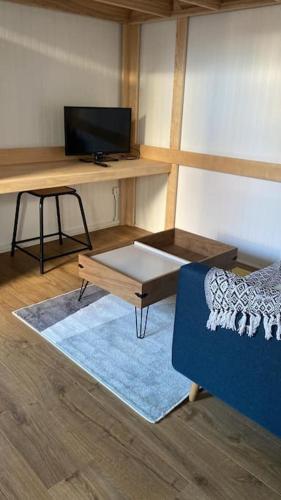 a room with a desk and a couch and a table at Studio paisible à Lorient ! in Lorient